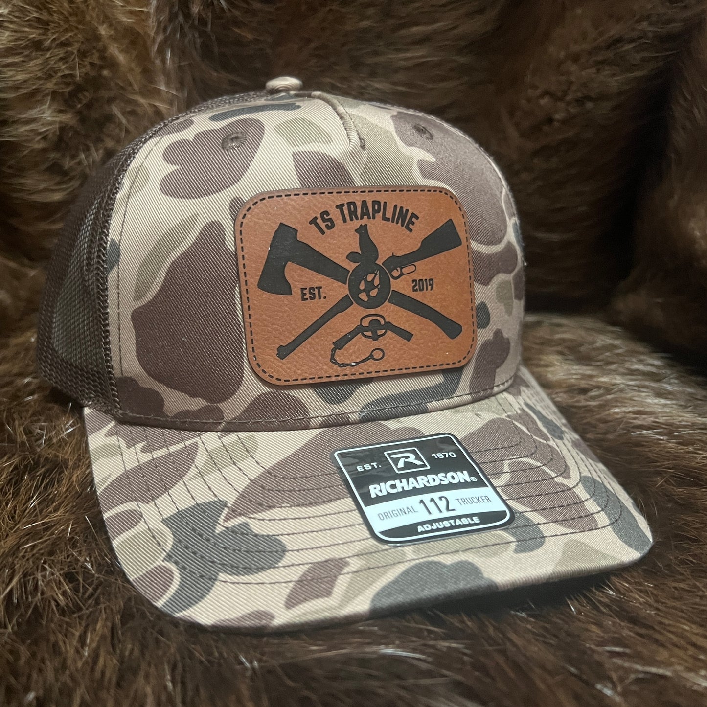 Richardson 112FP Mesh Back Trucker Hat w/ Brown Leather Ax & Rifle Logo Patch