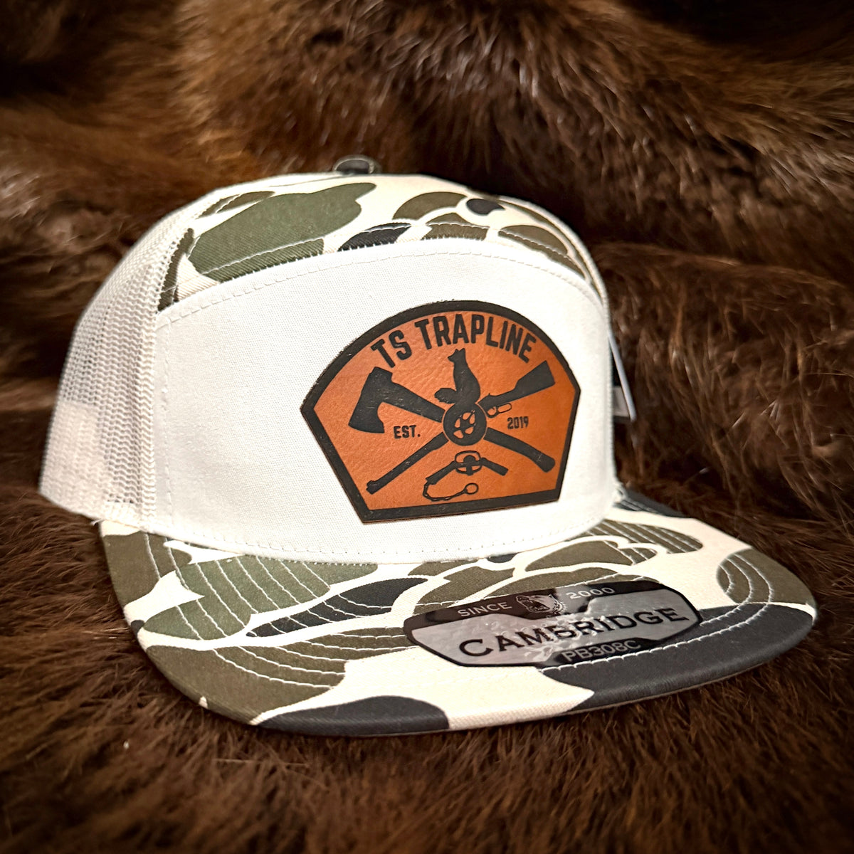 7 Panel Camo Mesh Back Trucker w/ Ax & Rifle “Tombstone” Leather patch