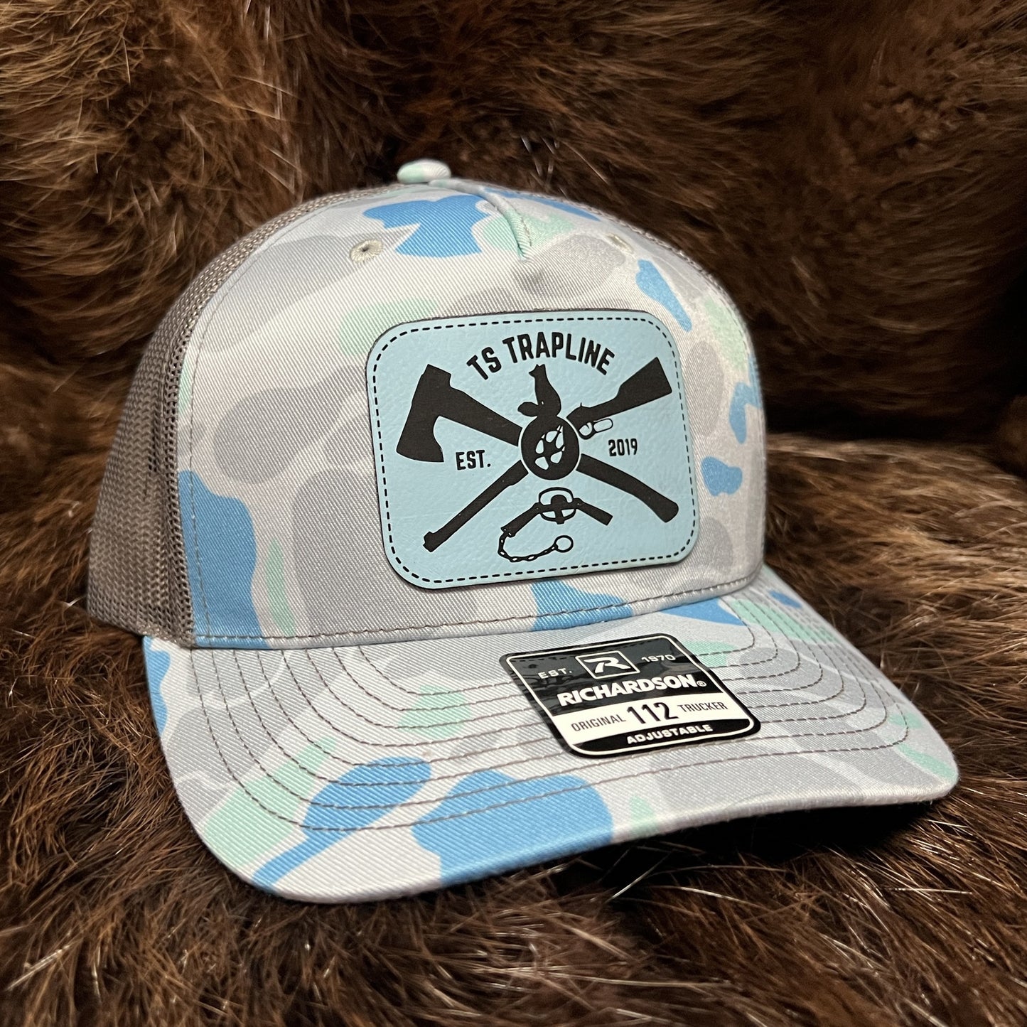 Richardson 112FP Mesh Back Trucker Hat w/ Blue Leather Ax & Rifle Logo Patch