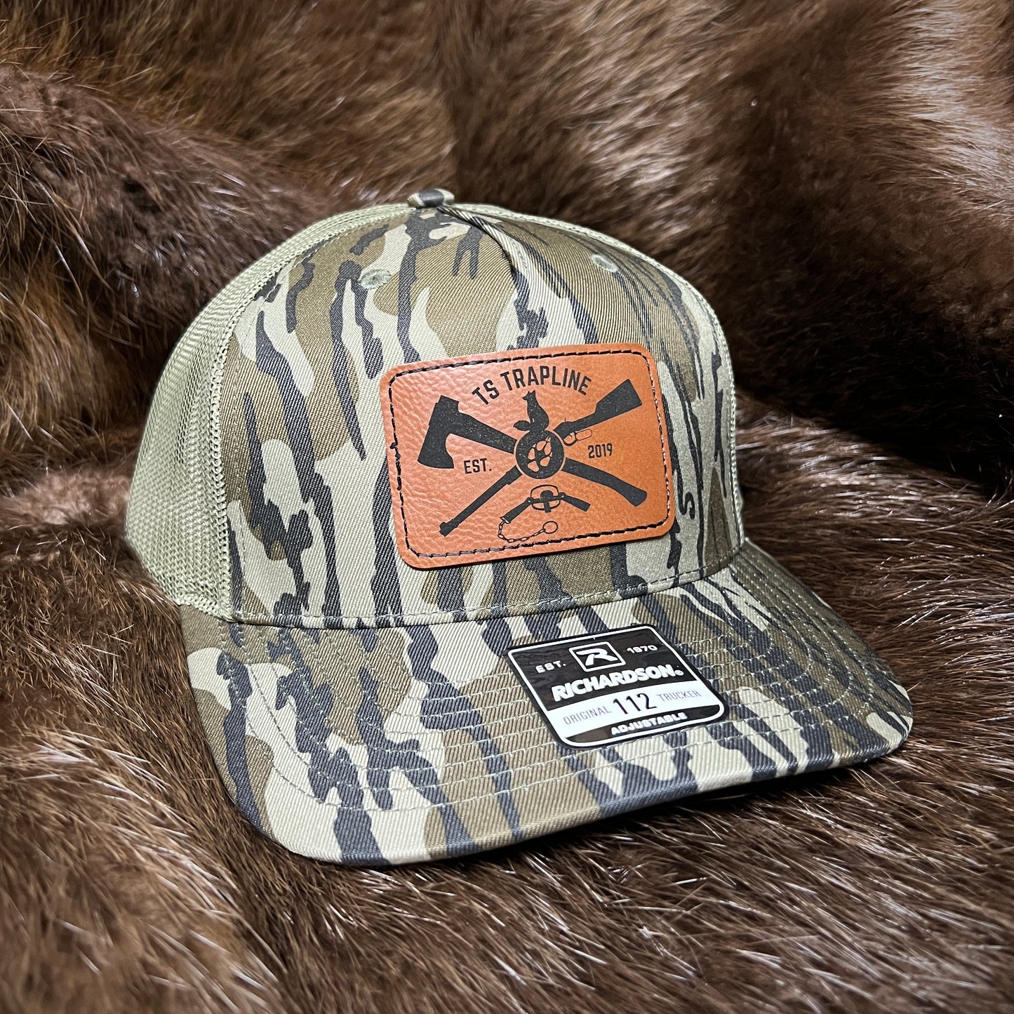 Richardson 112FP Mesh Back Trucker Hat w/ Brown Leather Ax & Rifle Logo Patch