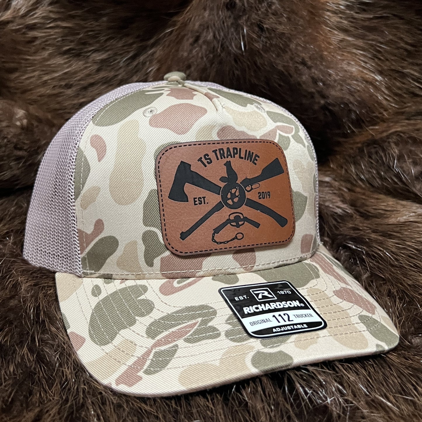Richardson 112FP Mesh Back Trucker Hat w/ Brown Leather Ax & Rifle Logo Patch