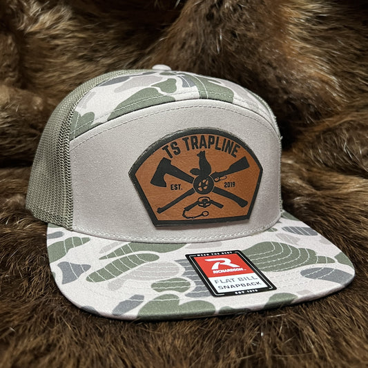 Richardson 7 Panel Camo Mesh Back Trucker w/ Ax & Rifle “Tombstone” Leather patch